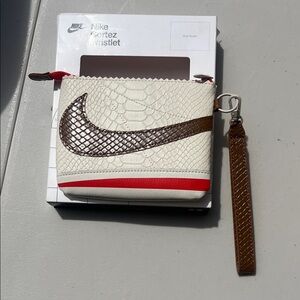 Nike Cream Wristlet with Brown Swoosh and Red Accent